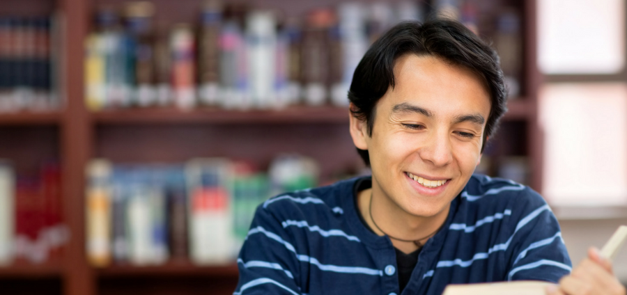 Man reading book smiling