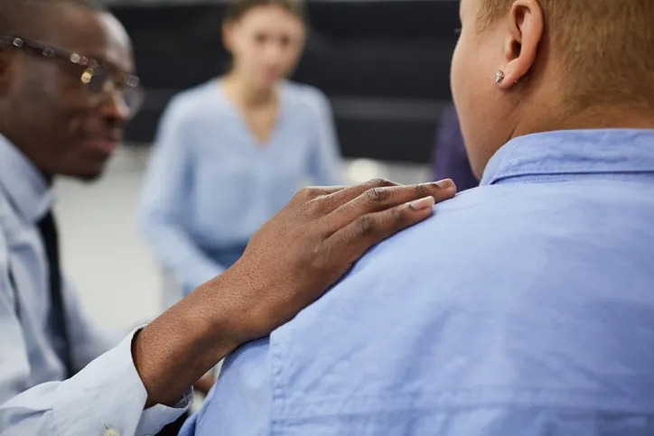 Man putting hand on friend shoulder